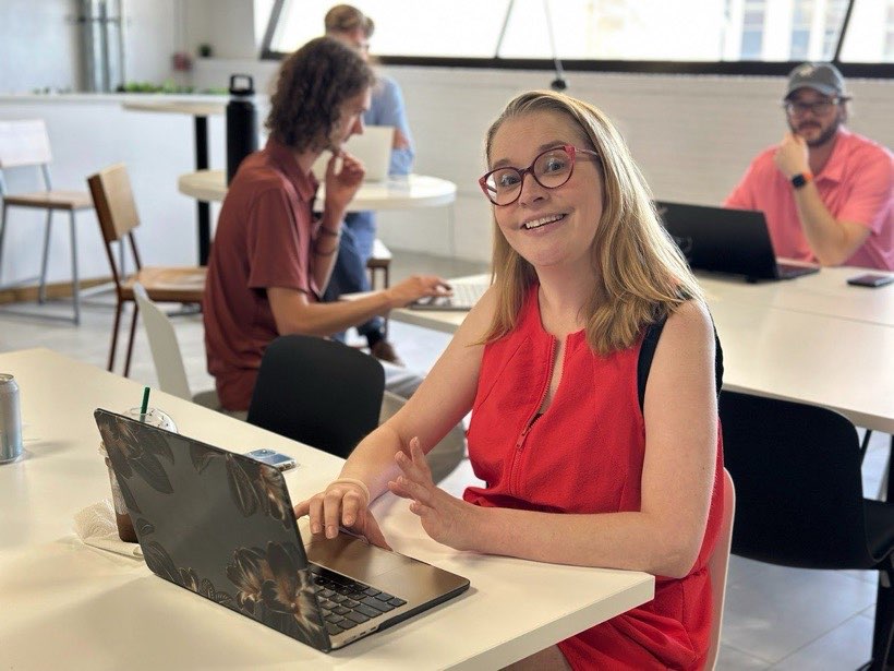 Two attendees working together at a laptop